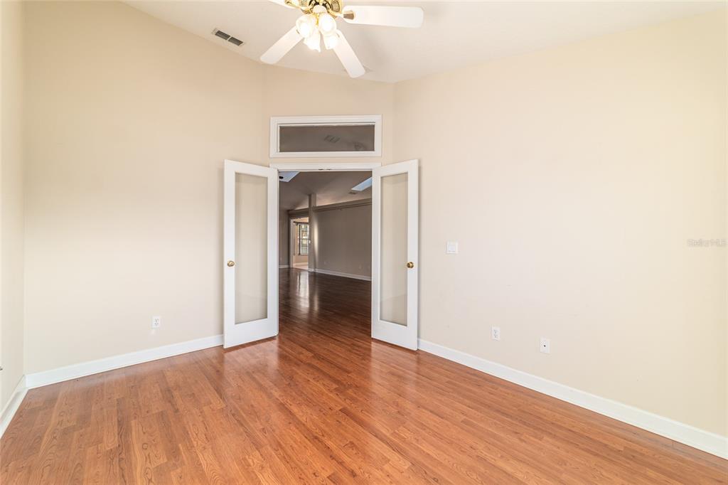 9611 Southwest 45th Avenue Ocala, FL 34476 - Photo 31 of 56 a view of a hallway with wooden floor and a chandelier