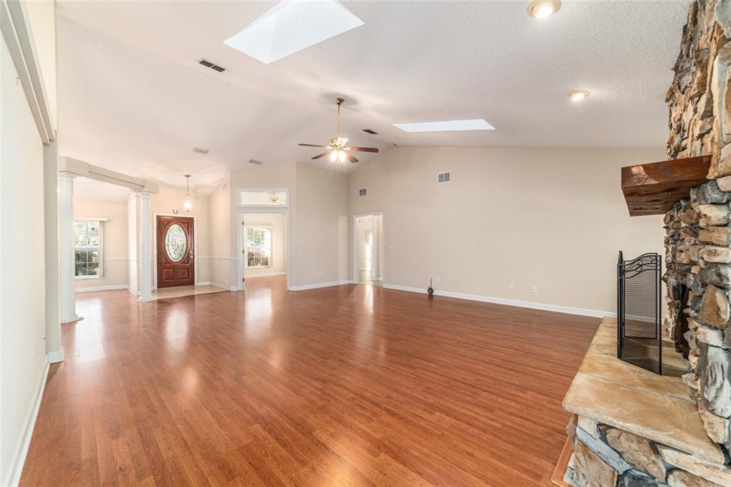 9611 Southwest 45th Avenue Ocala, FL 34476 - Photo 9 of 56 a view of an empty room with wooden floor