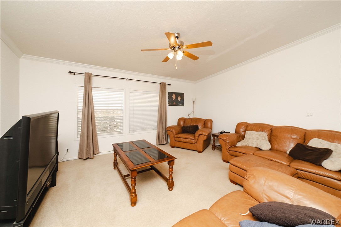 3190 East Pepper Tree Road Kingman, AZ 86409 - Photo 4 of 67 a living room with furniture and a flat screen tv