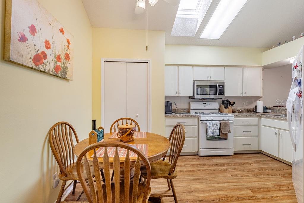 6555 Wilander Street Leesburg, FL 34748 - Photo 13 of 45 a view of a dining room with furniture and wooden floor