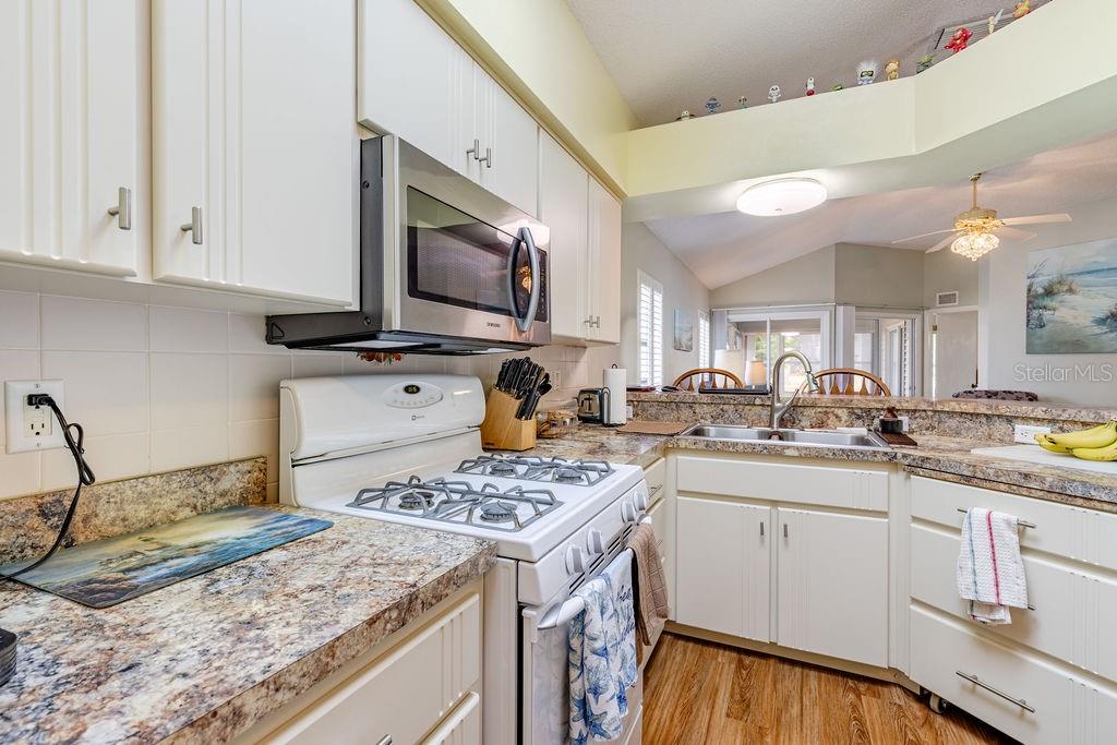 6555 Wilander Street Leesburg, FL 34748 - Photo 15 of 45 a kitchen with a sink stove and cabinets