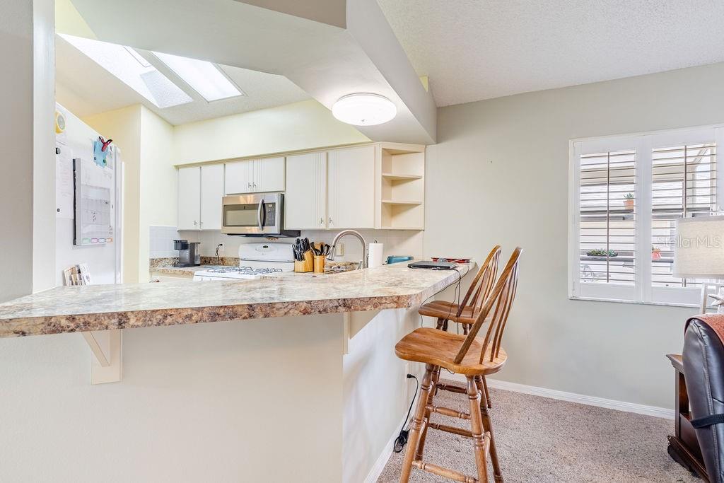 6555 Wilander Street Leesburg, FL 34748 - Photo 16 of 45 a dining room with granite countertop furniture and a fireplace