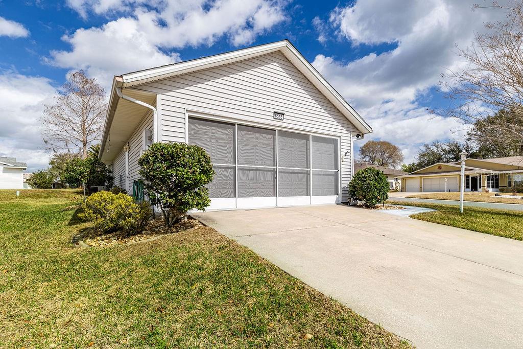 6555 Wilander Street Leesburg, FL 34748 - Photo 2 of 45 a front view of a house with a yard and garage