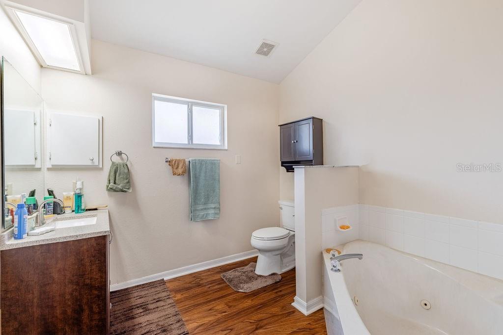 6555 Wilander Street Leesburg, FL 34748 - Photo 24 of 45 a bathroom with a toilet and a sink