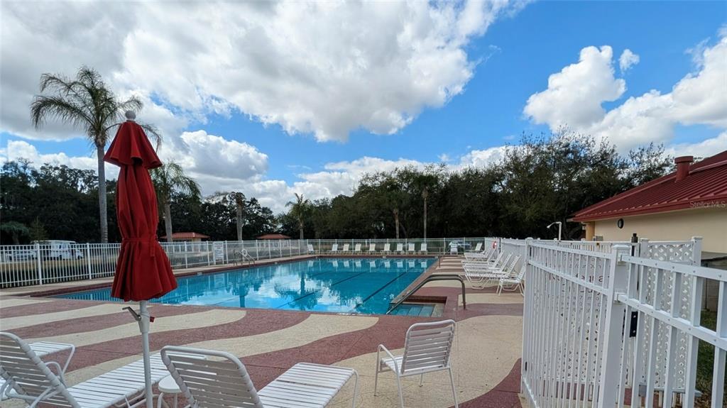 6555 Wilander Street Leesburg, FL 34748 - Photo 45 of 45 a view of a patio with a table chairs fire pit and wooden fence