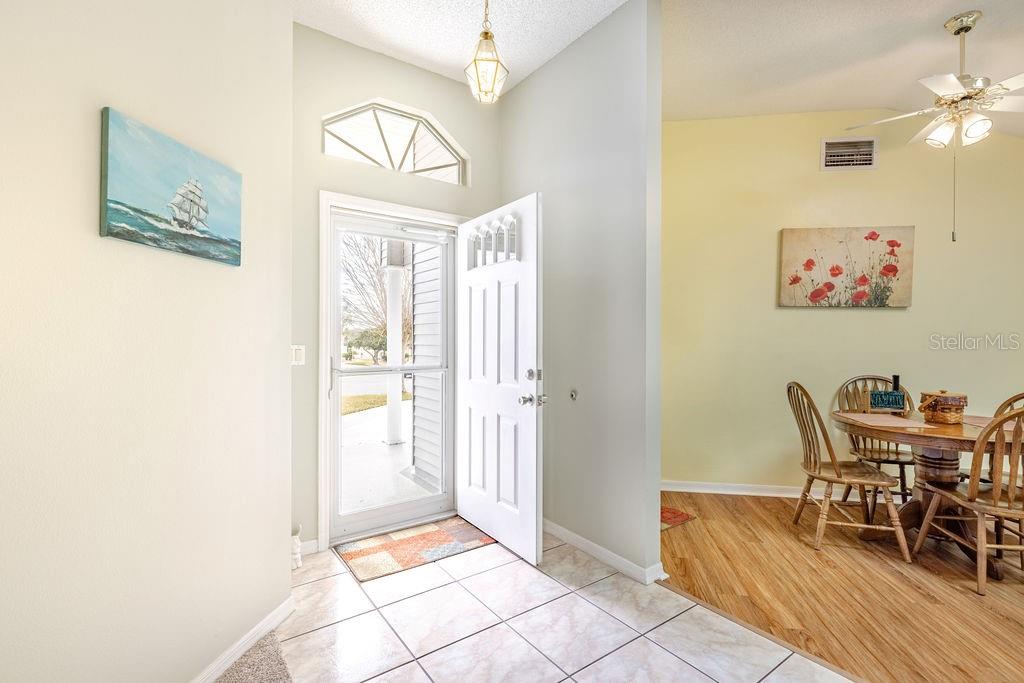 6555 Wilander Street Leesburg, FL 34748 - Photo 7 of 45 a view of a dining room with furniture and a chandelier
