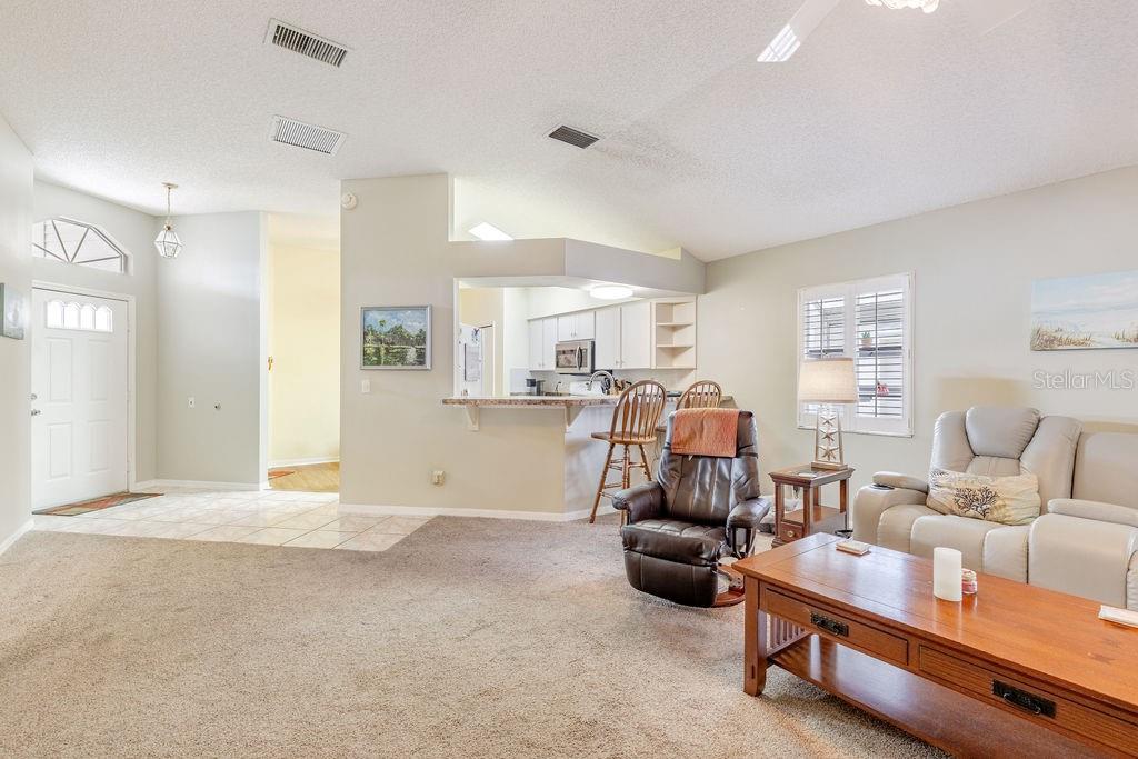 6555 Wilander Street Leesburg, FL 34748 - Photo 8 of 45 a living room with furniture and a flat screen tv