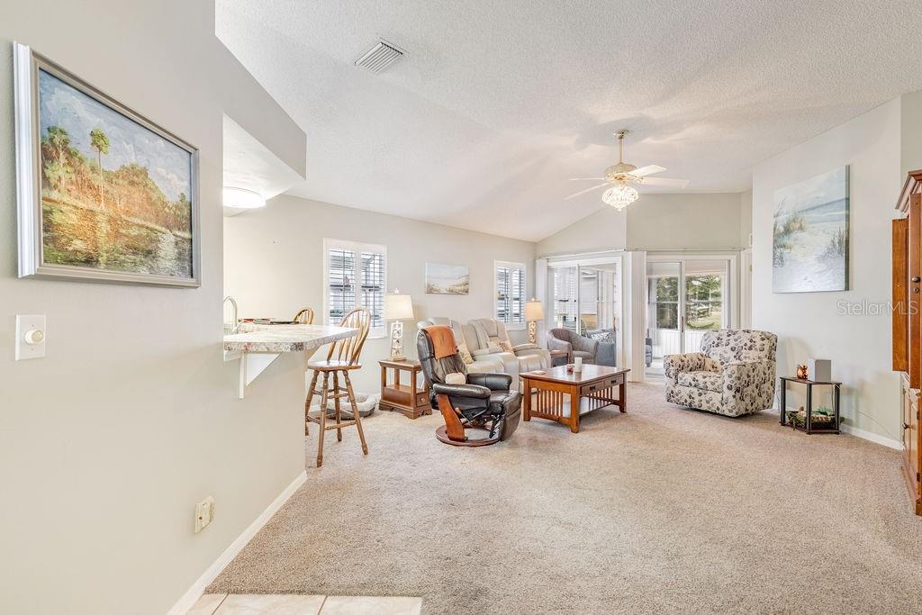 6555 Wilander Street Leesburg, FL 34748 - Photo 9 of 45 a living room with furniture and a chandelier