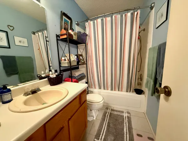 a bathroom with a sink toilet and mirror