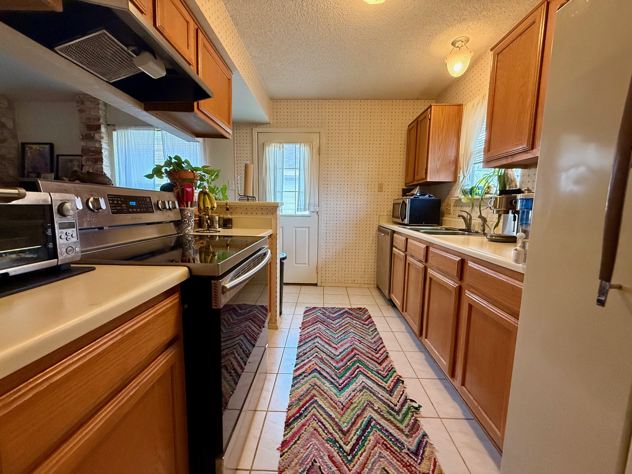 16704 Whitebrush Loop Austin, TX 78717 - Photo 9 of 20 a kitchen with stainless steel appliances granite countertop a sink stove and refrigerator
