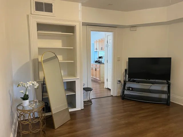 a living room with furniture and flat screen tv