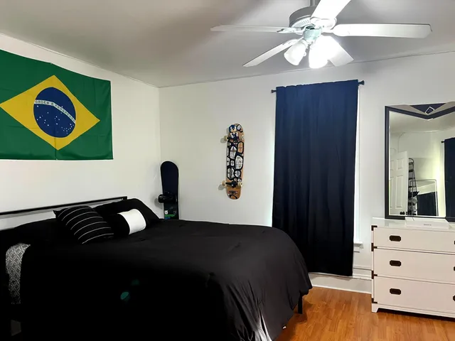 a bedroom with a bed and a painting on the wall