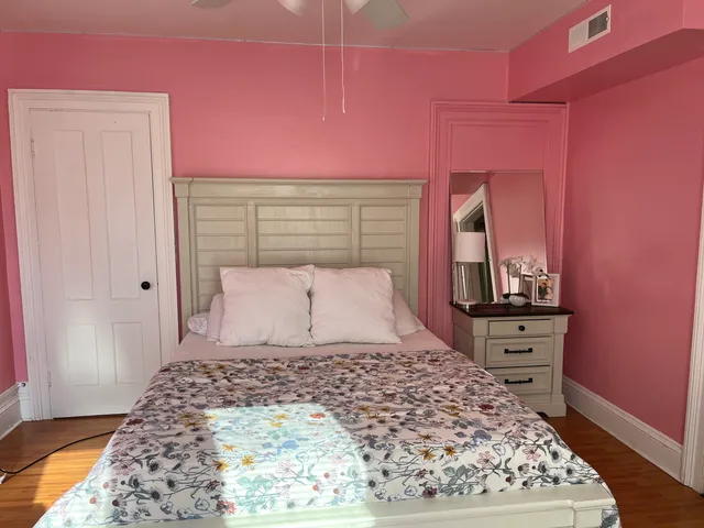 a large bed with a wooden floor