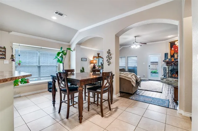 a living room with furniture and a dining table