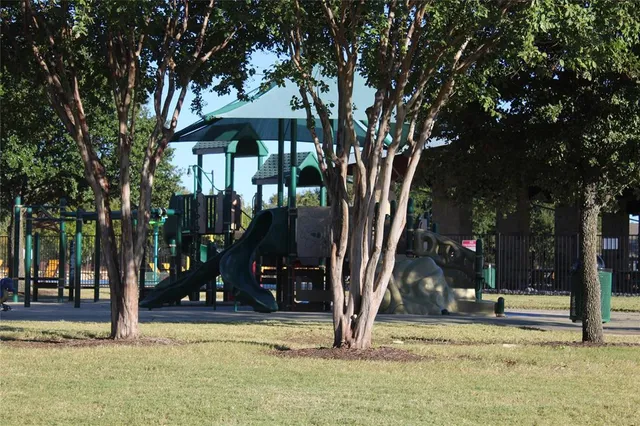 a view of a park with swings and slides