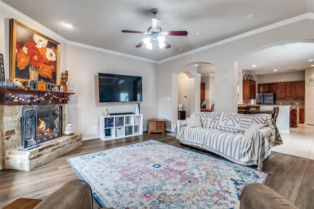 a spacious bedroom with a bed a couch and a flat screen tv