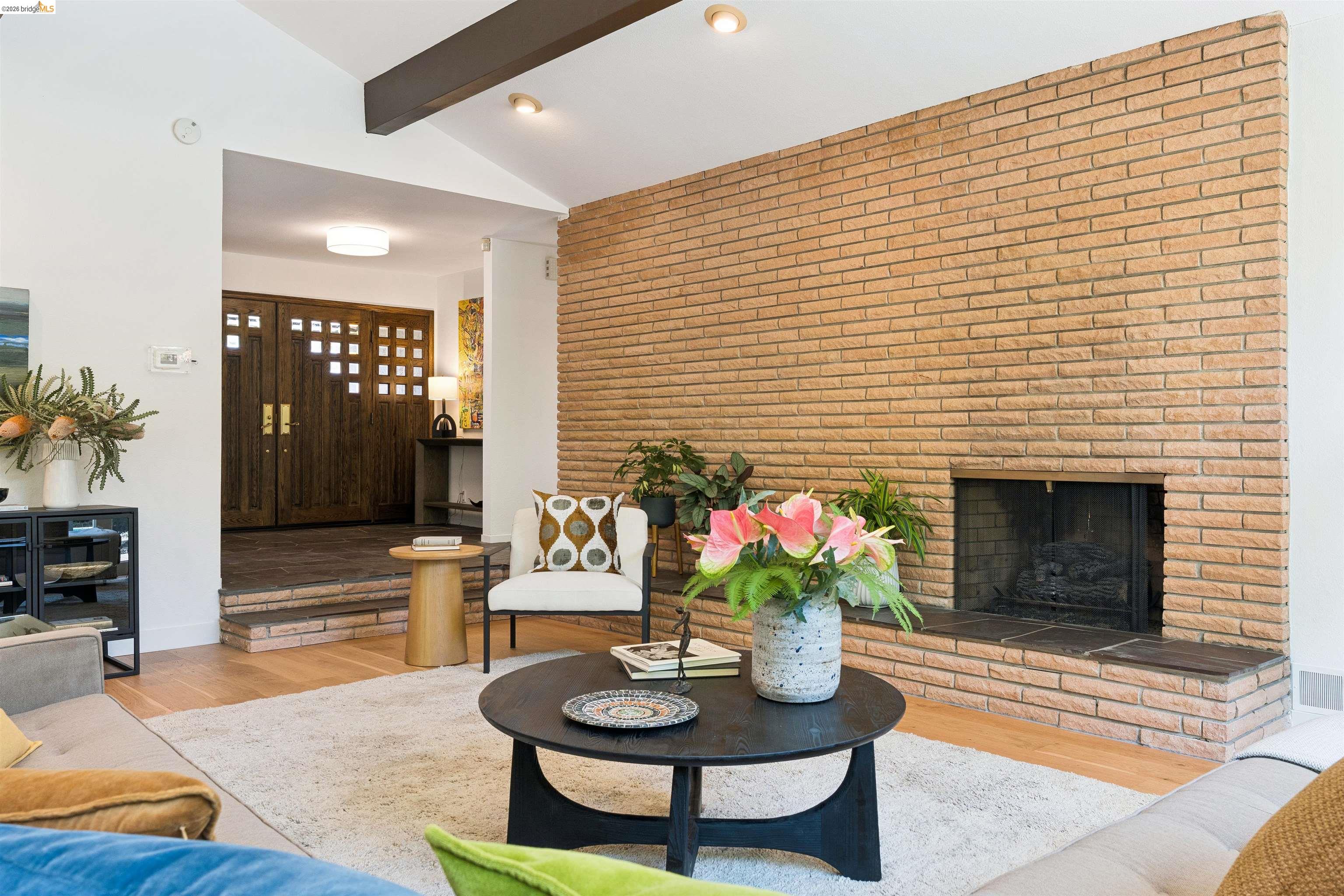 7 Jo Lin Court El Sobrante, CA 94803 - Photo 34 of 99 Expansive living area featuring a prominent brick fireplace with a raised hearth