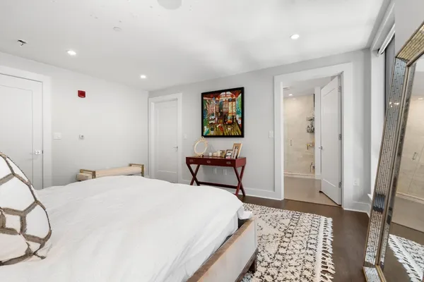 a bedroom with a bed and a rug