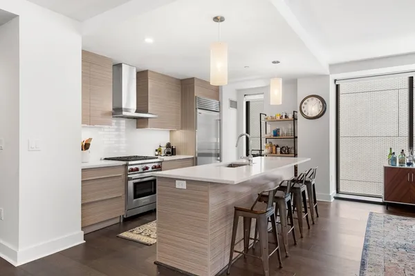 a kitchen with a table chairs stove and cabinets