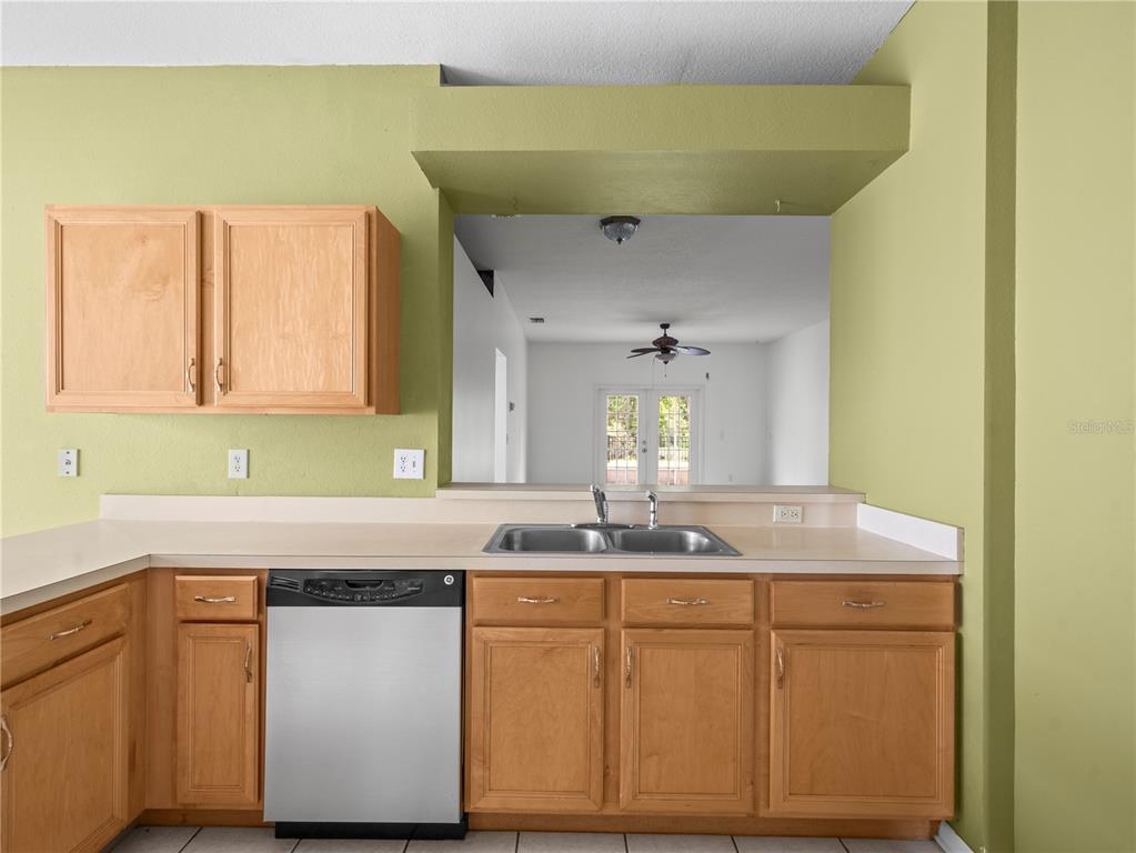 30638 Nickerson Loop Wesley Chapel, FL 33543 - Photo 14 of 39 a kitchen with stainless steel appliances granite countertop a sink and cabinets