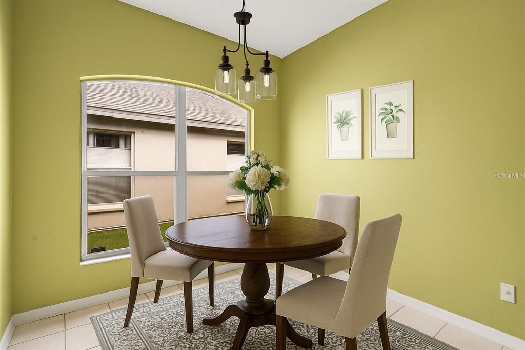30638 Nickerson Loop Wesley Chapel, FL 33543 - Photo 15 of 39 a view of a dining room with furniture and a chandelier
