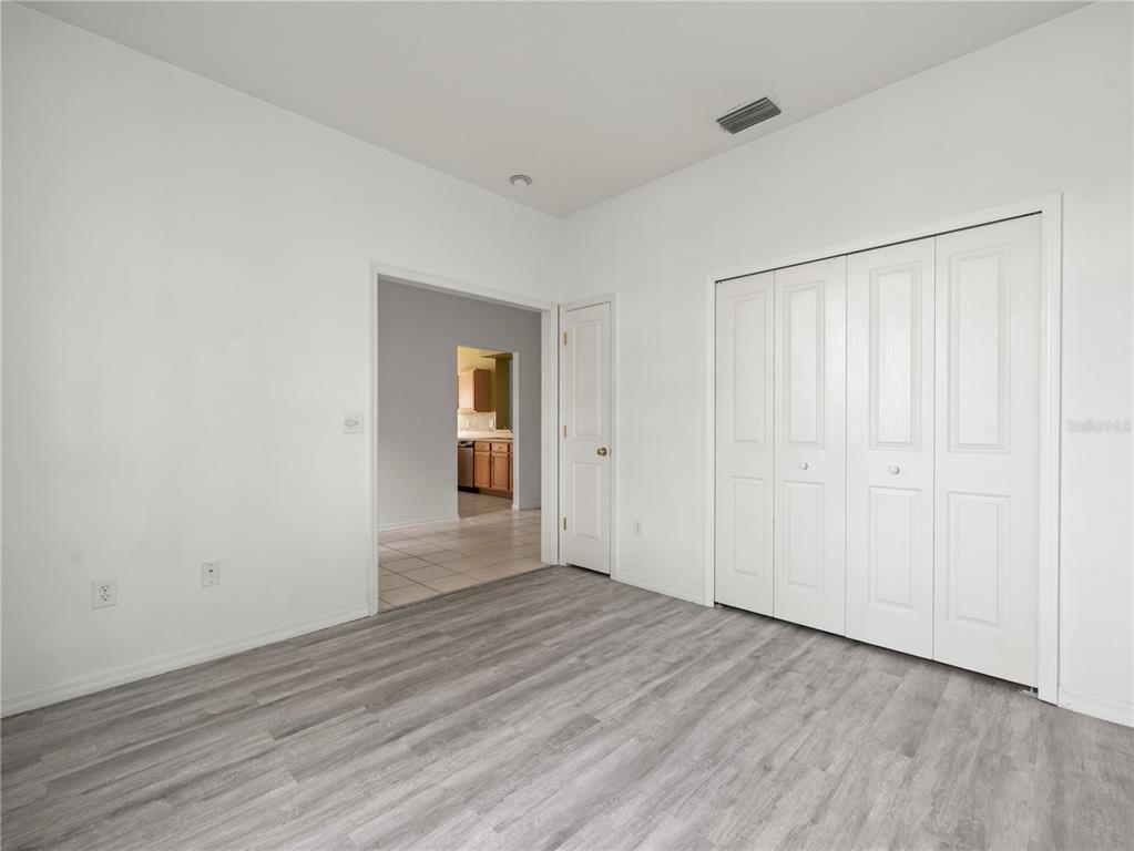 30638 Nickerson Loop Wesley Chapel, FL 33543 - Photo 24 of 39 a view of an empty room with wooden floor