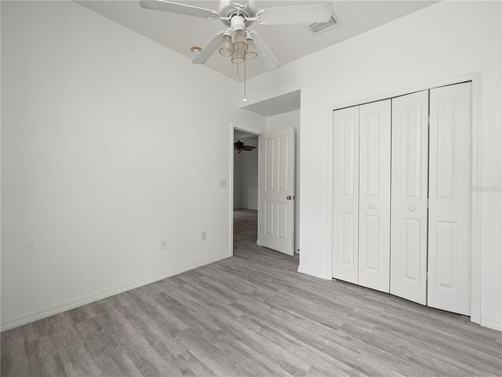 30638 Nickerson Loop Wesley Chapel, FL 33543 - Photo 26 of 39 a view of an empty room with wooden floor