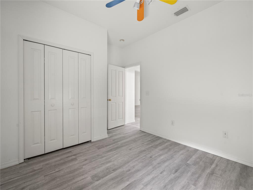 30638 Nickerson Loop Wesley Chapel, FL 33543 - Photo 29 of 39 a view of an empty room with wooden floor
