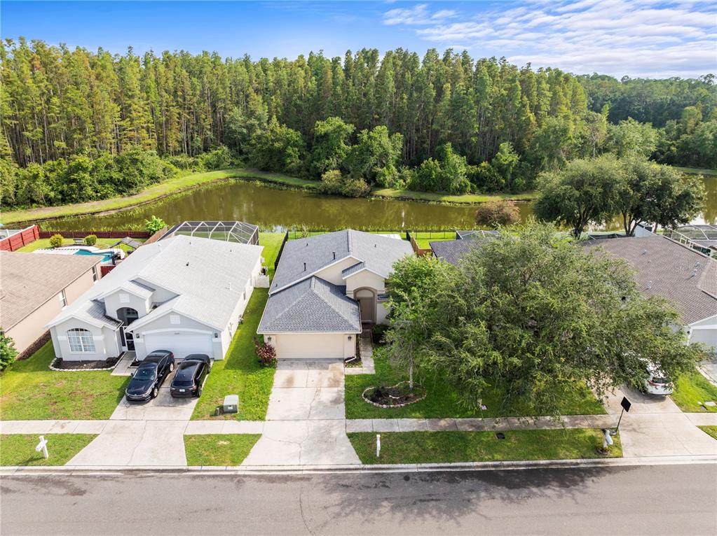 30638 Nickerson Loop Wesley Chapel, FL 33543 - Photo 7 of 39 an aerial view of a house with a garden and lake view