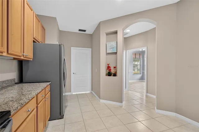 a view of a kitchen with a refrigerator and a window