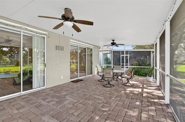 a view of a porch with chairs and backyard