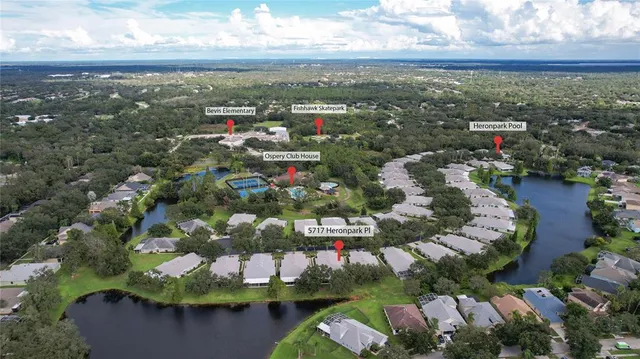 an aerial view of a residential houses with yard and swimming pool