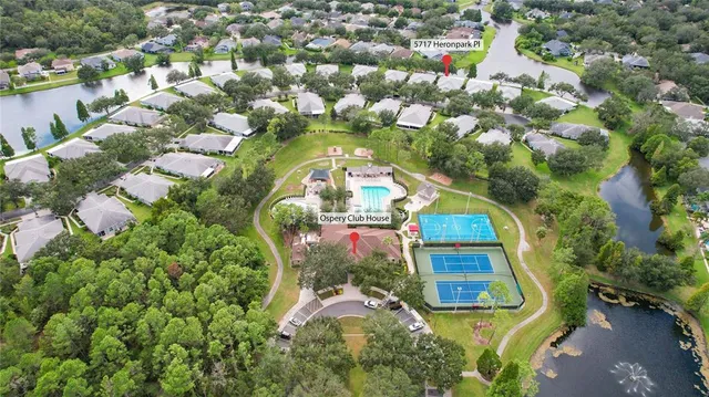 an aerial view of a house with outdoor space pool seating area and yard