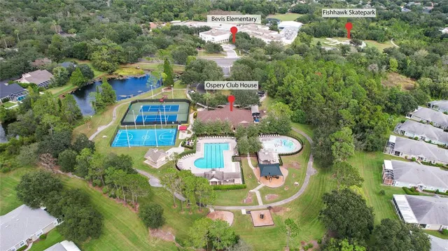 an aerial view of a residential houses with yard