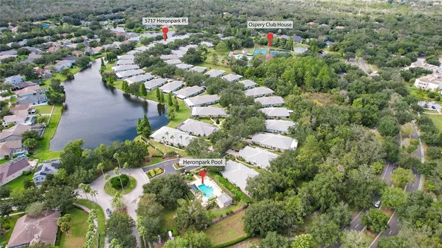 an aerial view of a house with swimming pool and outdoor seating