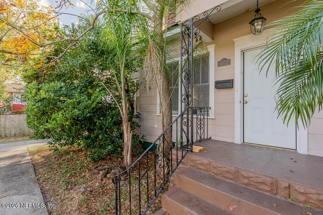 a view of a house with a tree