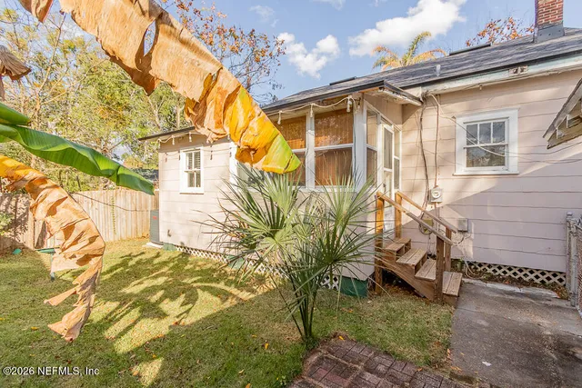 a view of a blue house with a yard