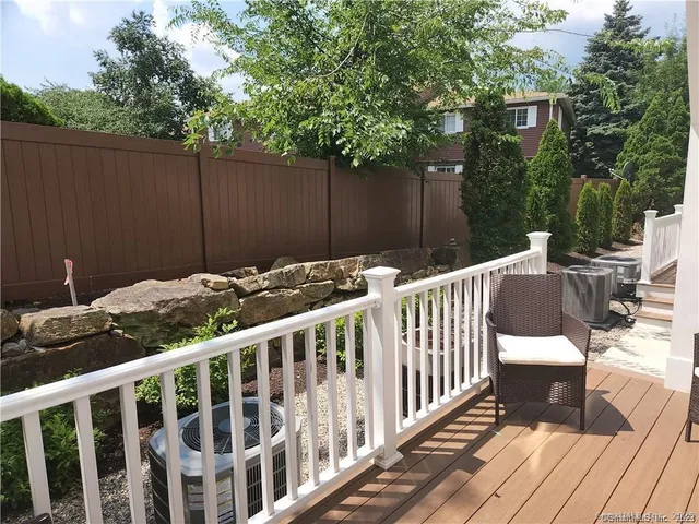 a view of a deck with furniture and wooden fence
