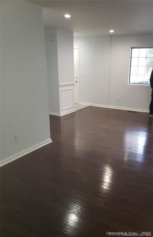 3200 Madison Avenue, Unit D10 Bridgeport, CT 06606 - Photo 2 of 12 an empty room with wooden floor and windows