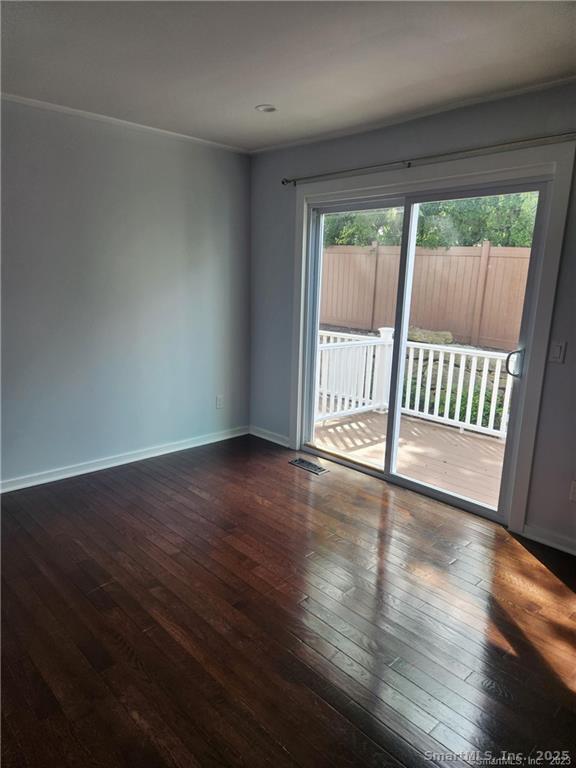 3200 Madison Avenue, Unit D10 Bridgeport, CT 06606 - Photo 8 of 12 a view of an empty room with wooden floor and a window