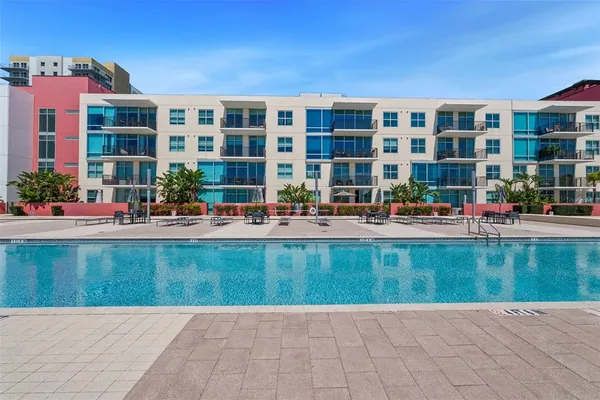 a swimming pool with outdoor seating and yard