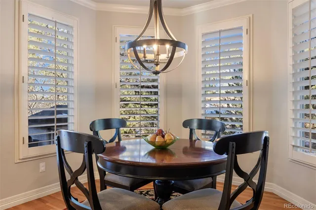 a kitchen with stainless steel appliances granite countertop a sink a stove and a wooden floors