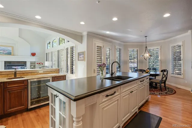 a kitchen with granite countertop a sink appliances and cabinets