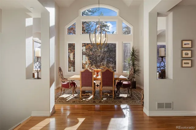 a living room with furniture a table and wooden floor