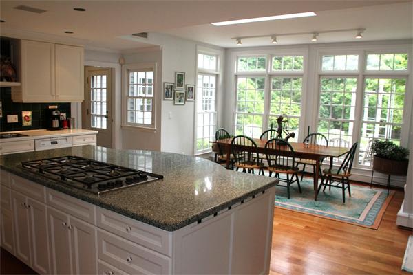 6 Wampatuck Road Dedham, MA 02026 - Photo 13 of 30 a kitchen with granite countertop a stove a table and chairs in it