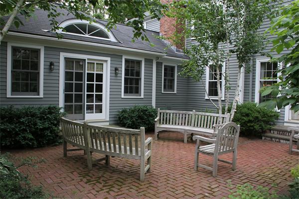 6 Wampatuck Road Dedham, MA 02026 - Photo 5 of 30 a view of a house with a bench in the patio