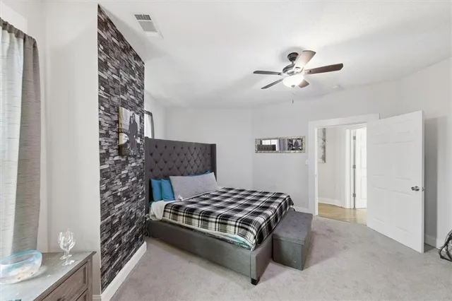 a bedroom with furniture and a flat screen tv