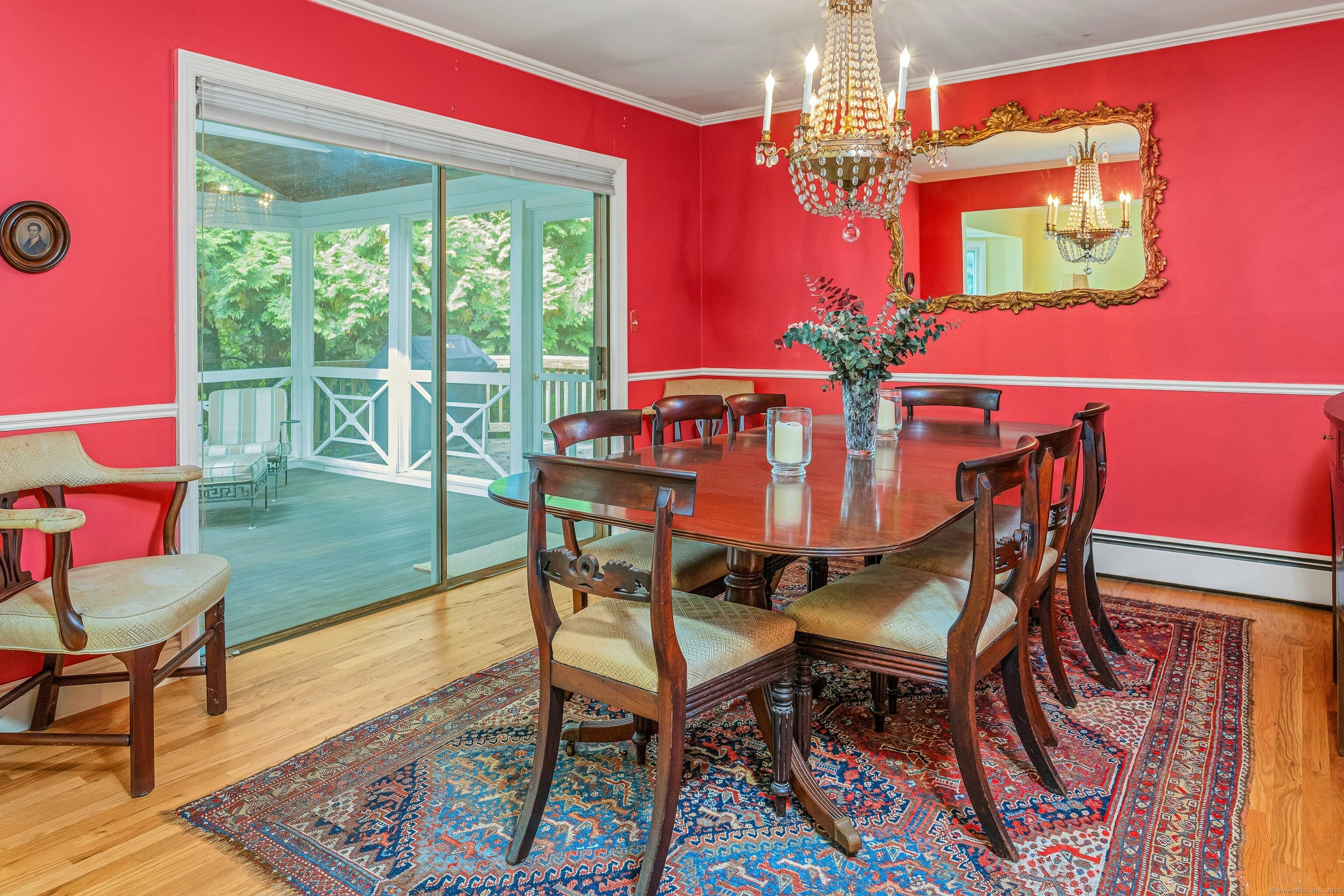261 Linden Tree Road Wilton, CT 06897 - Photo 12 of 27 a dining room with furniture a chandelier and wooden floor