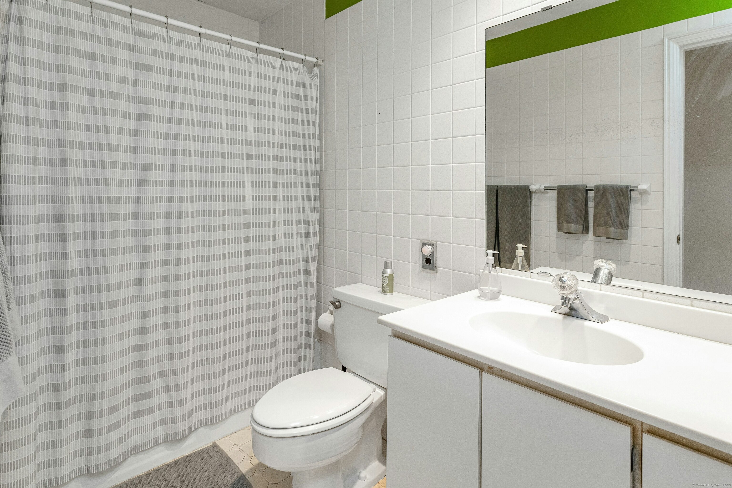 261 Linden Tree Road Wilton, CT 06897 - Photo 20 of 27 a bathroom with a sink a toilet and mirror