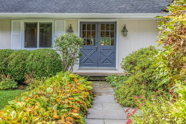a front view of a house with a yard